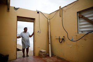 Irma Torres at her damaged house after the area was hit by Hurricane Maria