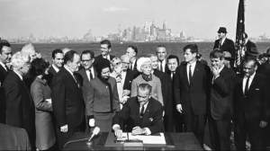 Lyndon B. Johnson signing the Immigration Act of 1964 into place